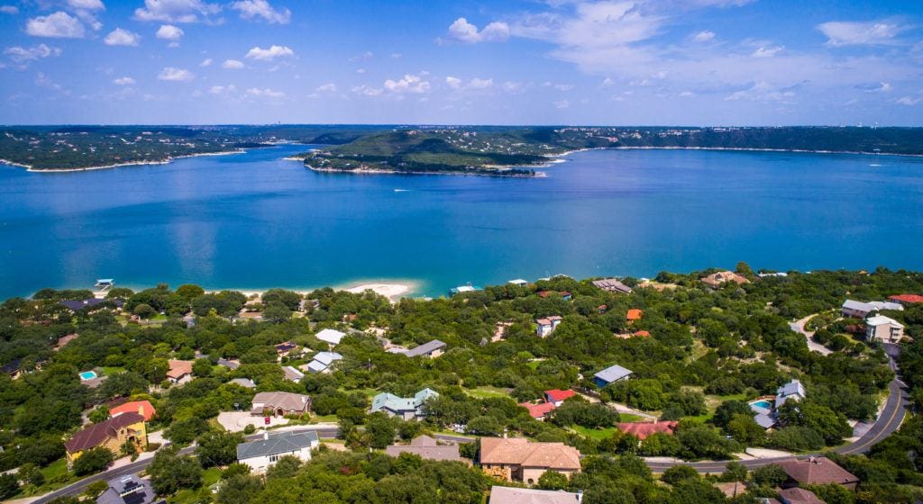 Colorful rooftops and mansions aerial view above Lake Travis and